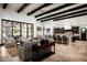 Spacious living room flows into a kitchen, featuring travertine floors and modern lighting at 5016 E Butler Dr, Paradise Valley, AZ 85253