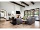 Inviting living room with a cozy fireplace, travertine floors, and modern decor at 5016 E Butler Dr, Paradise Valley, AZ 85253