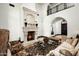 Cozy living room featuring a stone fireplace, high ceilings, and travertine floors at 5016 E Butler Dr, Paradise Valley, AZ 85253