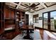 Executive office with a coffered ceiling, custom built-ins, and a dark wood desk, creating a sophisticated workspace at 5016 E Butler Dr, Paradise Valley, AZ 85253