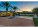 Luxury home with a pool, fountains, lush landscaping, and a mountain backdrop at sunset at 5016 E Butler Dr, Paradise Valley, AZ 85253