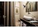 Chic powder room featuring a vessel sink, decorative mirror, and custom vanity at 5016 E Butler Dr, Paradise Valley, AZ 85253