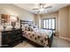 Cozy bedroom featuring a ceiling fan, neutral walls, and a decorative headboard, creating a relaxing retreat at 5350 E Deer Valley Dr # 3277, Phoenix, AZ 85054