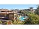 View of the community featuring a pool area and mature vegetation alongside residential architecture on a clear day at 5350 E Deer Valley Dr # 3277, Phoenix, AZ 85054