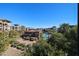 View of the community featuring a pool area and mature vegetation alongside residential architecture on a clear day at 5350 E Deer Valley Dr # 3277, Phoenix, AZ 85054