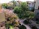 Landscaped courtyard featuring flowering trees, walkways, and mature shade trees within a multi-story building complex at 5350 E Deer Valley Dr # 3277, Phoenix, AZ 85054