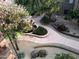 An elevated view of a landscaped courtyard with winding pathways, mature trees, and attractive planting beds at 5350 E Deer Valley Dr # 3277, Phoenix, AZ 85054