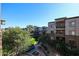 Exterior view of the community showcasing manicured lawns, mature trees, and beautiful building architecture on a sunny day at 5350 E Deer Valley Dr # 3277, Phoenix, AZ 85054