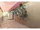 Backyard view of a wall lined with bicycles under a shaded cover and adjacent to a storage unit at 5401 N 81St Pl, Scottsdale, AZ 85250