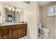 Bathroom with a tiled floor, an ornate countertop, a commode, and a window at 5401 N 81St Pl, Scottsdale, AZ 85250