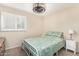 Bright bedroom featuring carpet flooring, window with shutters, and light green bedding at 5401 N 81St Pl, Scottsdale, AZ 85250