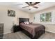 Comfortable bedroom featuring a ceiling fan, closet, and ample natural light from window at 5401 N 81St Pl, Scottsdale, AZ 85250