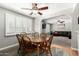 Dining room featuring a round wood table and chairs with a large window with shutters at 5401 N 81St Pl, Scottsdale, AZ 85250