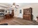 Open living space featuring wood floors, kitchen bar with granite counters, and a vintage wood china cabinet at 5401 N 81St Pl, Scottsdale, AZ 85250