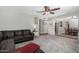 Comfortable living room featuring a cozy couch, carpet floors, and access to the dining room at 5401 N 81St Pl, Scottsdale, AZ 85250