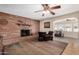 Cozy living room featuring a brick fireplace, comfortable seating, and an open layout for seamless entertaining at 5401 N 81St Pl, Scottsdale, AZ 85250