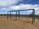 Community playground with classic swings and wood chip safety surface for worry-free outdoor play at 5515 W Hopi Trl, Laveen, AZ 85339