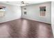 An empty bedroom with hardwood floors, neutral paint and a ceiling fan at 5822 W Huntington Dr, Laveen, AZ 85339