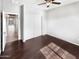 Cozy bedroom featuring wood floors, a ceiling fan and a spacious closet at 5822 W Huntington Dr, Laveen, AZ 85339