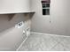 Laundry room with tile floor, a window, and built in shelving at 5822 W Huntington Dr, Laveen, AZ 85339