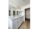 Bright bathroom with double sinks, white cabinets, and a large mirror at 60 W Shamrock St, Gilbert, AZ 85233