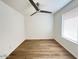 Bright bedroom featuring modern ceiling fan and light, with sleek wood-look flooring and large window at 60 W Shamrock St, Gilbert, AZ 85233