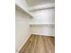 Spacious walk-in closet featuring wood-look flooring and built-in shelving for storage at 60 W Shamrock St, Gilbert, AZ 85233