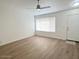 Bright living room with wood-look flooring, a ceiling fan, and natural light from large windows at 60 W Shamrock St, Gilbert, AZ 85233