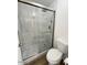 Modern bathroom with tiled shower, glass door, gray tiling, and tiled floor at 60 W Shamrock St, Gilbert, AZ 85233