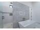 Elegant bathroom showcasing a soaking tub, large gray tiles, and a walk-in shower at 6378 S 154Th St, Gilbert, AZ 85298