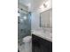 Contemporary bathroom featuring a glass shower, tiled walls, and a sleek vanity with marble countertop at 6378 S 154Th St, Gilbert, AZ 85298