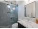 Modern bathroom with gray tiled shower, glass door, marble countertop, and chrome fixtures at 6378 S 154Th St, Gilbert, AZ 85298