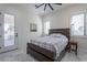 Bright bedroom featuring rustic wood furniture, white walls, large windows with shutter and marble tile flooring at 6378 S 154Th St, Gilbert, AZ 85298