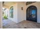 Elegant front entrance featuring tiled flooring, arched windows, and custom wrought iron double doors at 6378 S 154Th St, Gilbert, AZ 85298