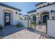 Elegant front entrance with wrought iron gate and landscaped walkway leading to the door at 6378 S 154Th St, Gilbert, AZ 85298