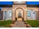 Close up of front entrance with covered portico, decorative lighting, and ironwork at 6378 S 154Th St, Gilbert, AZ 85298