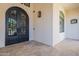 Luxurious front entrance with ornate wrought iron double doors and tiled flooring at 6378 S 154Th St, Gilbert, AZ 85298