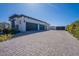 Long paved driveway leading to the three-car garage, and black metal gate at 6378 S 154Th St, Gilbert, AZ 85298