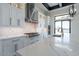 Bright kitchen featuring white cabinets, stainless steel range hood, and a marble countertop island with seating at 6378 S 154Th St, Gilbert, AZ 85298