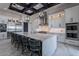 Spacious kitchen featuring large island with seating, white cabinetry, stainless steel appliances, and modern lighting at 6378 S 154Th St, Gilbert, AZ 85298