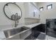 A modern laundry room featuring stainless steel sink, quartz counters, and front loading washer/dryer at 6378 S 154Th St, Gilbert, AZ 85298