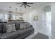 Open floor plan featuring a gray sofa with decorative pillows, open to the kitchen with bar seating at 6378 S 154Th St, Gilbert, AZ 85298