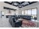 Open-concept living area with gray sofas, a modern kitchen, and large windows providing abundant natural light at 6378 S 154Th St, Gilbert, AZ 85298