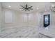 Bright living room with white marble-style floors, ceiling fan and white walls at 6378 S 154Th St, Gilbert, AZ 85298