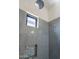 Walk-in shower featuring gray tile, mosaic tile niche, rain shower head, and a window at 6378 S 154Th St, Gilbert, AZ 85298