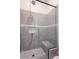 Modern shower featuring gray tile surround, a glass enclosure, and a built-in bench at 6378 S 154Th St, Gilbert, AZ 85298