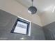 Shower featuring grey tile walls, modern showerhead, window, and neutral decor at 6378 S 154Th St, Gilbert, AZ 85298