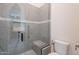 Walk-in shower with a glass door, gray tile, a shower seat, and modern fixtures at 6378 S 154Th St, Gilbert, AZ 85298