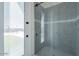 Walk-in shower featuring glass door and gray tile at 6378 S 154Th St, Gilbert, AZ 85298