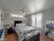 This main bedroom features plank accent wall, wood floors, and a ceiling fan at 652 S Ellsworth Rd # 46, Mesa, AZ 85208